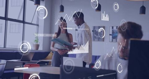 Collaborating team analyzing business data with interactive dashboards in modern office