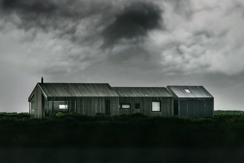 Minimal Modern Timber House Facing Stormy Sky on Remote Grassland, Moody Architecture