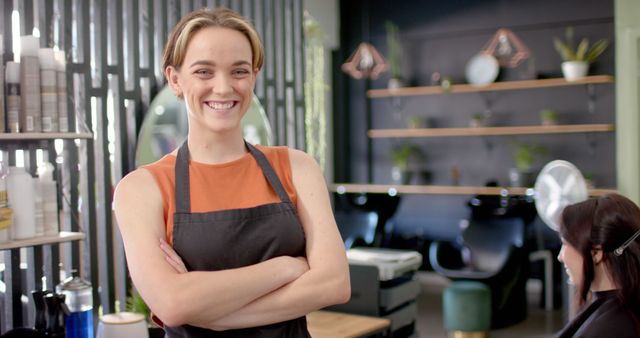 Smiling Female Hairdresser with Apron in Salon - Download Free Stock Images Pikwizard.com