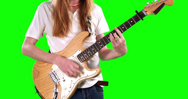 Ideal for music-related projects, tutorials, album art, or promotional materials. The green screen background allows for easy editing and overlaying different environments. Useful for advertising music lessons or creating engaging social media content focusing on guitar skills and performance.