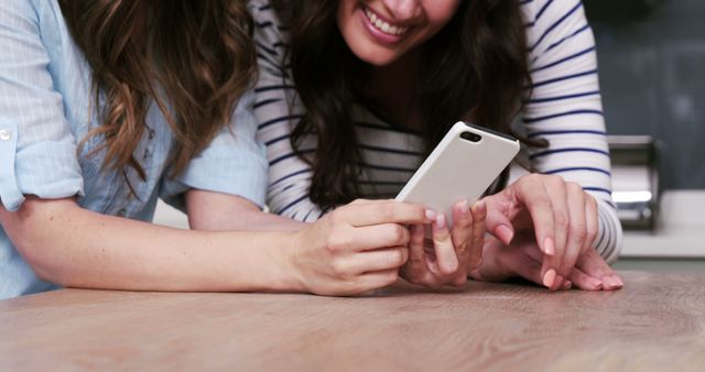 Two Friends Smiling and Using Smartphone Together - Download Free Stock Images Pikwizard.com