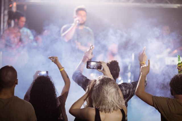 Fans Enjoying Live Music Concert at Nightclub - Download Free Stock Photos Pikwizard.com