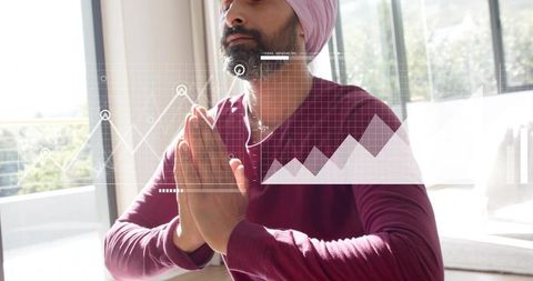 Meditating man wearing pink turban practicing mindfulness in sunlit minimalist balcony