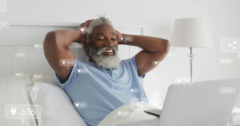 Senior African American Man Relaxing With Laptop and Digital Interactions