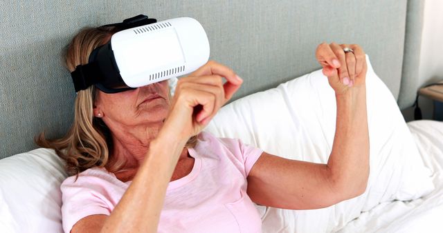Senior Woman Experiencing Virtual Reality in Bedroom - Download Free Stock Images Pikwizard.com