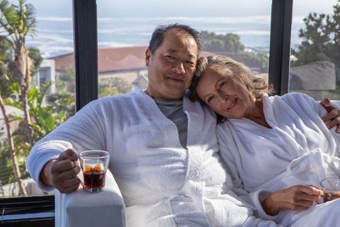 Relaxing Senior Couple in Luxury Home Enjoying Morning Coffee