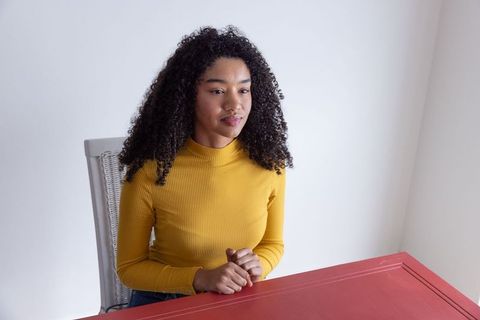 Contemplative African American Woman at Minimalist Home Workspace