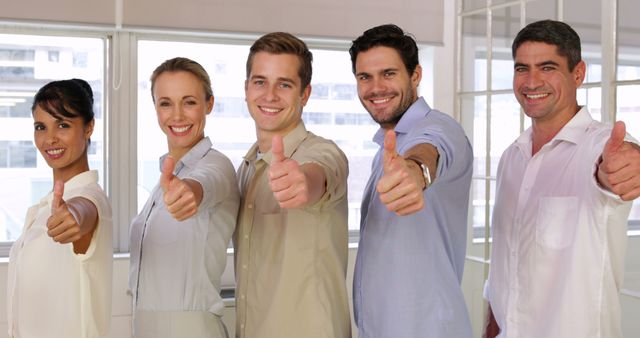 Diverse Team Giving Thumbs Up in Office Setting - Download Free Stock Images Pikwizard.com