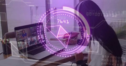 Middle eastern teen in hijab writing while attending virtual class on laptop at home desk