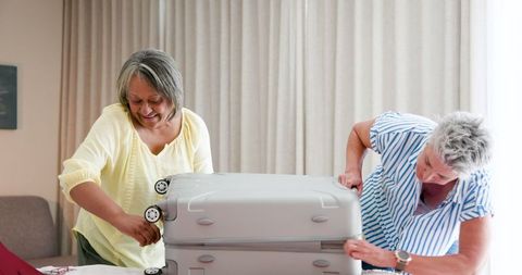 Senior couple packing suitcases for exciting vacation adventure