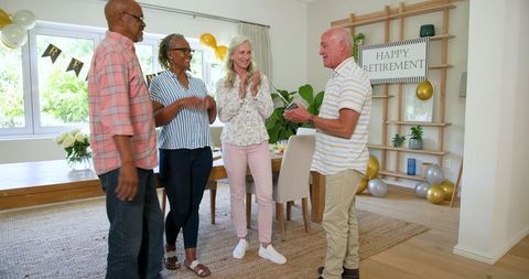 Senior Friends Celebrating Happy Retirement with Laughter and Cheers