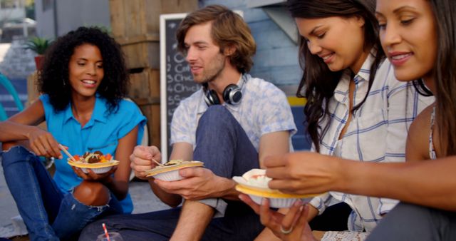 A group of young adults shares a joyful and relaxed meal outdoors. - Download Free Stock Photos Pikwizard.com