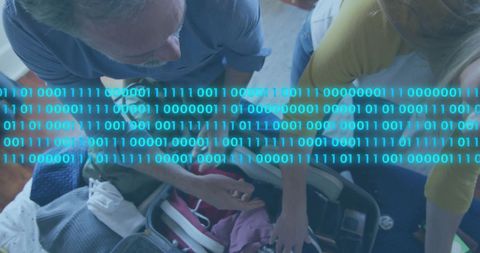 Binary code overlay on traveling couple packing suitcase