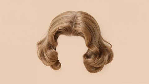 Vintage light brown wavy hairpiece on beige canvas