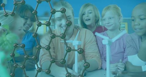 Children and teacher exploring renewable energy models and molecular science in classroom
