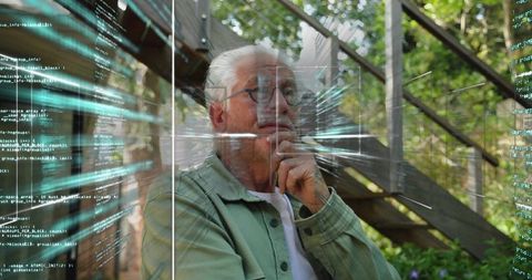 Senior man contemplating digital future through glass with code overlay on sunny porch