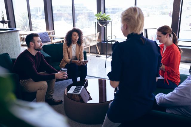 Multi ethnic group of professional businesswomen and businessman working in a modern creative office, having a meeting brainstorming interacting. Business creativity meeting.