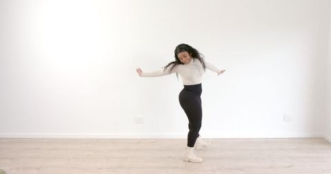 Graceful Woman Performing Dance Sequence Indoors