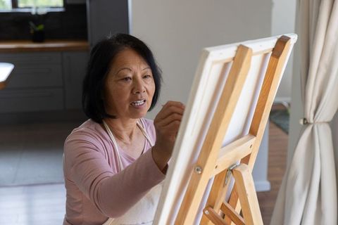 Senior Woman Engaging in Creative Painting at Home