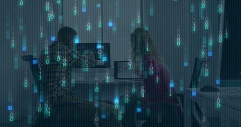 Collaborators debugging code at workstation with falling binary data overlay