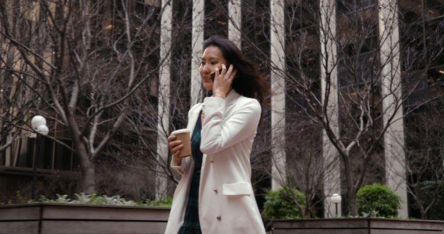 Professional Woman Walking and Talking on Cell Phone in Urban Setting - Download Free Stock Images Pikwizard.com