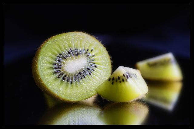 Close-up of Fresh Kiwi Fruit on Reflective Surface - Download Free Stock Photos Pikwizard.com