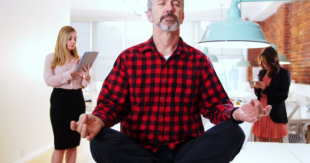 Businessman Meditating in Lotus Position in Modern Office - Download Free Stock Images Pikwizard.com