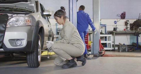 Female Mechanic Working HEBHydraulicenive ShrineComp: Professional Auto Repair Shop