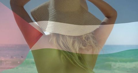 Woman in straw sun hat enjoying serene tropical beach
