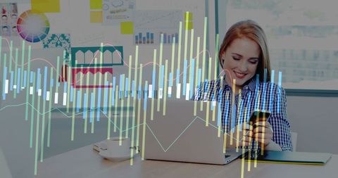 Woman Analyzing Data on Smartphone and Laptop in Modern Office