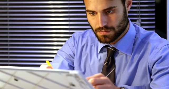 Focused Businessman Working on Tablet in Office - Download Free Stock Images Pikwizard.com