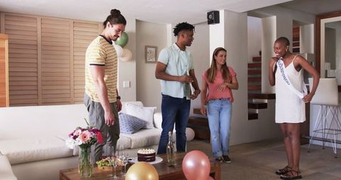 Friends Celebrating at Home with Balloons and Cake