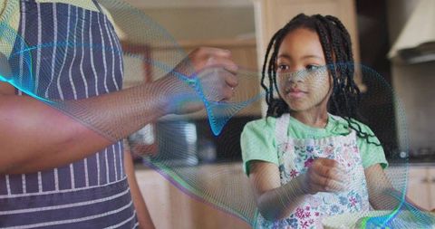 Dad teaching daughter to season food in home kitchen, cooking lesson family bonding memories