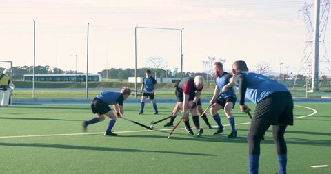 Intense field hockey match with focused players on turf pitch