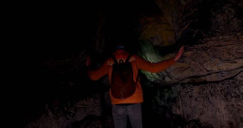 Man Exploring Mysterious Cave System in Darkness with Backpack - Download Free Stock Images Pikwizard.com