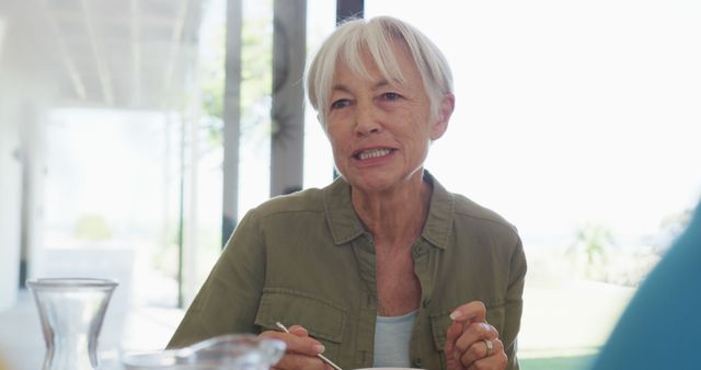 Senior Woman Enjoying Meal in Bright Room - Download Free Stock Images Pikwizard.com