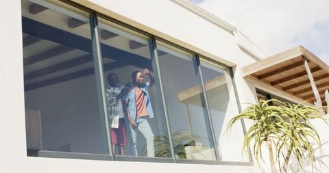 Father and Son Enjoying View from Modern Home Window - Download Free Stock Images Pikwizard.com