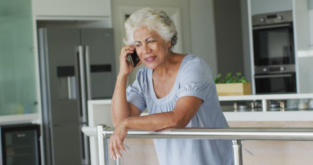 African american senior woman talking on smartphone at home. retirement senior lifestyle living in quarantine lockdown concept