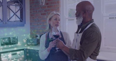 Senior Couple Sharing Wine in Modern Kitchen