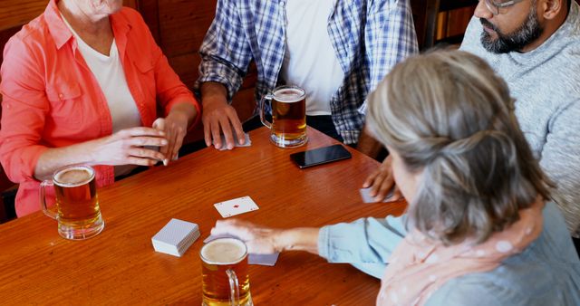 Group of Friends Enjoying Card Game at Pub - Download Free Stock Images Pikwizard.com