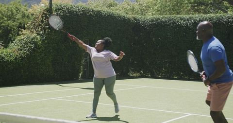Senior African American Couple Enjoying Tennis Together Outdoors