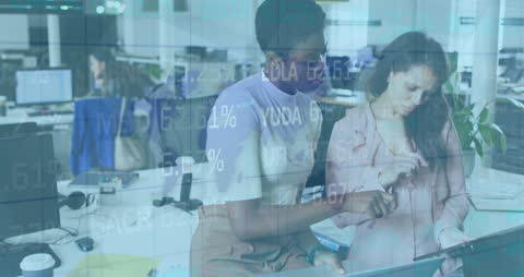 Businesswomen Analyzing Data in a Modern Office Environment