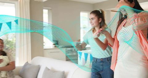 Smiling women celebrating at home holding newborn with abstract turquoise wave overlay