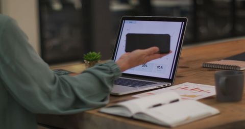 Caucasian businesswoman using laptop during office communication