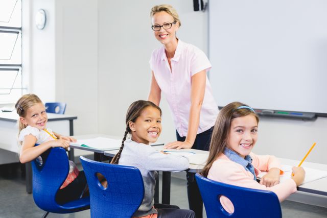 Teacher standing with smiling students in a classroom, ideal for educational materials, school brochures, and websites promoting positive learning environments. Perfect for illustrating concepts of teaching, student engagement, and classroom activities.