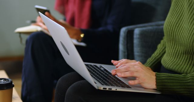 People using a laptop and smartphone while working in a relaxed environment - Download Free Stock Images Pikwizard.com