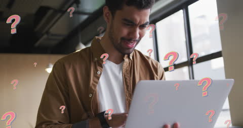 Stressed Businessman Working on Laptop Amid Questions