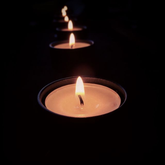 Row of Lit Tealight Candles in Dark Ambient - Download Free Stock Photos Pikwizard.com