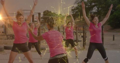 Diverse Women Exercising at Outdoor Obstacle Course with Digital Interface