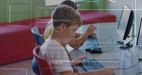 Elementary students coding on desktop computers with digital interface overlays